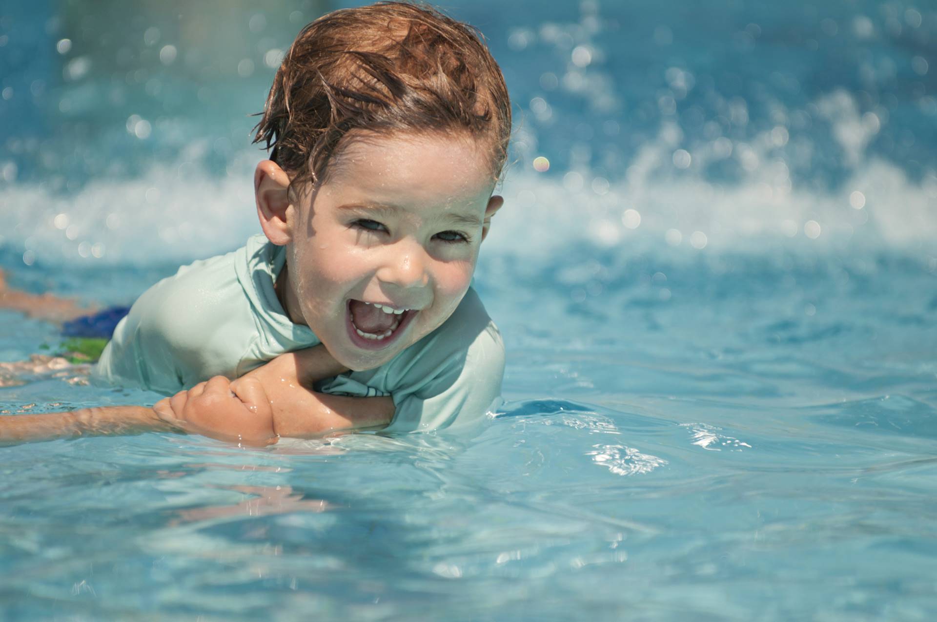 Happy child learning to swim